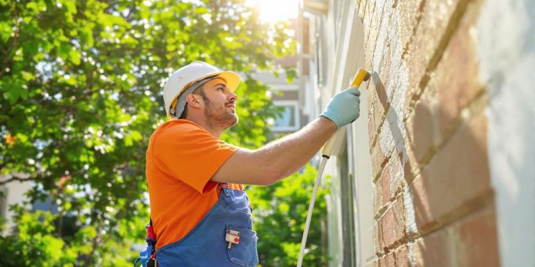 Contractor working outdoors in sunny weather.