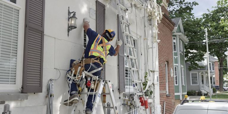Contractor working on a house exterior.