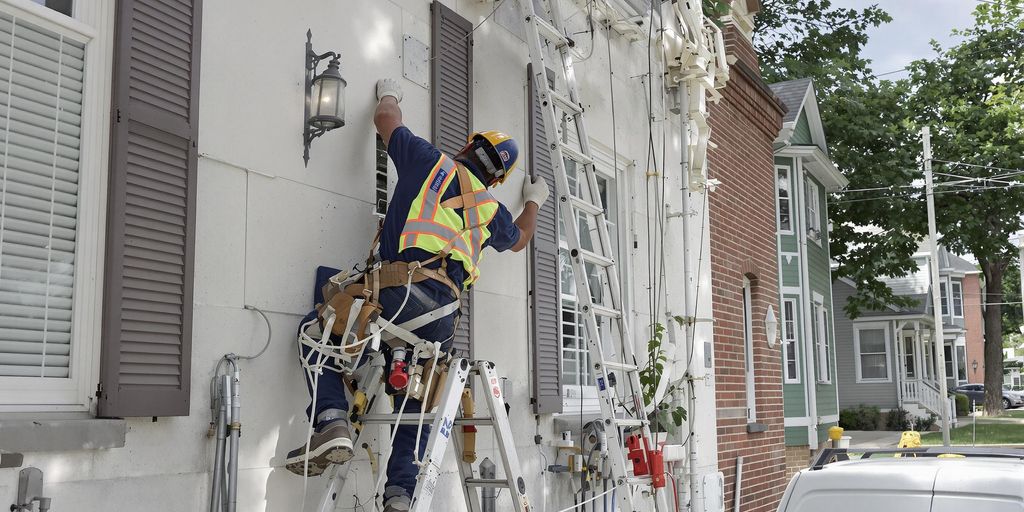 Contractor working on a house exterior.
