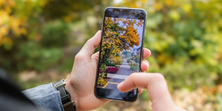 Contractor using a smartphone outdoors.