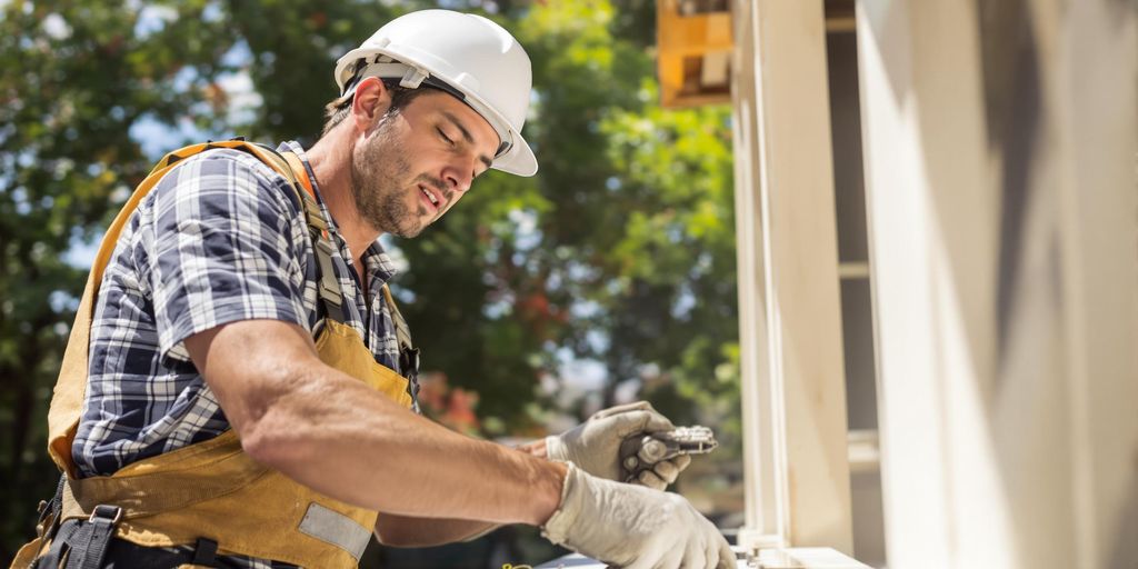 Contractor working in sunny summer outdoor setting.