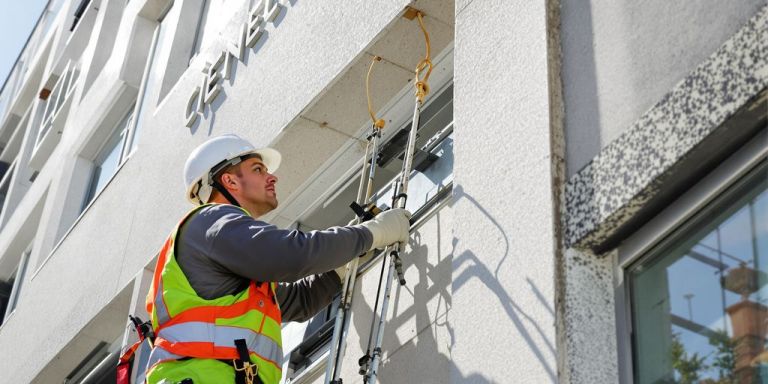 Contractor working on a building exterior.